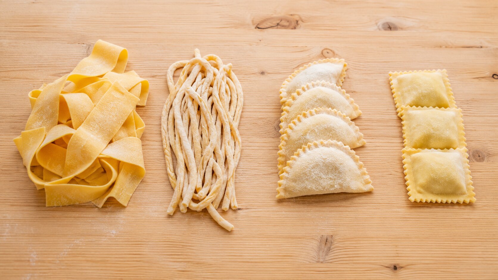 Traditional Tuscan pasta shapes on a wooden board