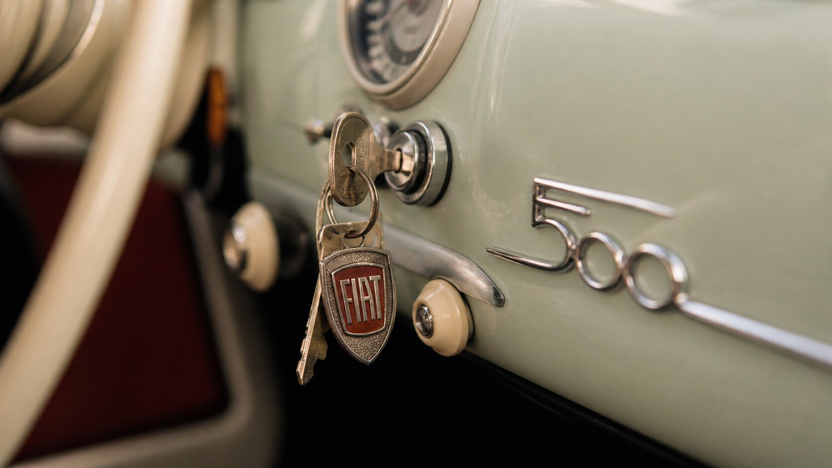 vintage Fiat 500 key in ignition dashboard detail