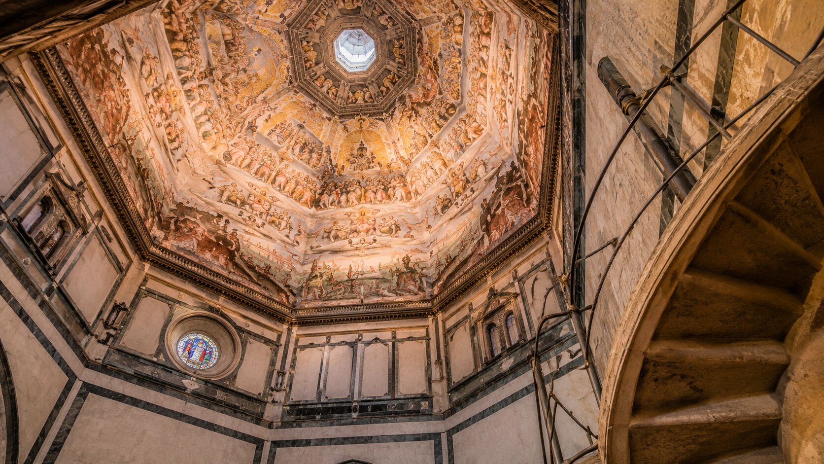 interior of Florence Duomo dome with frescoes and spiral staircase