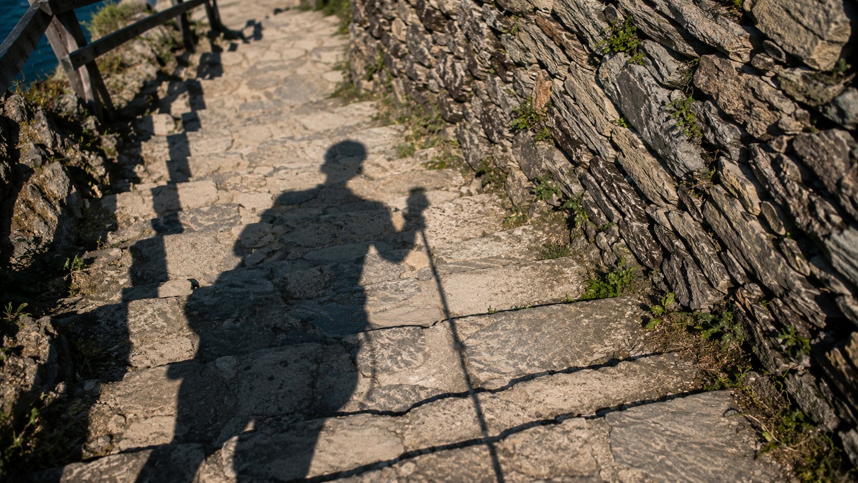 Hiker's shadow on stone steps