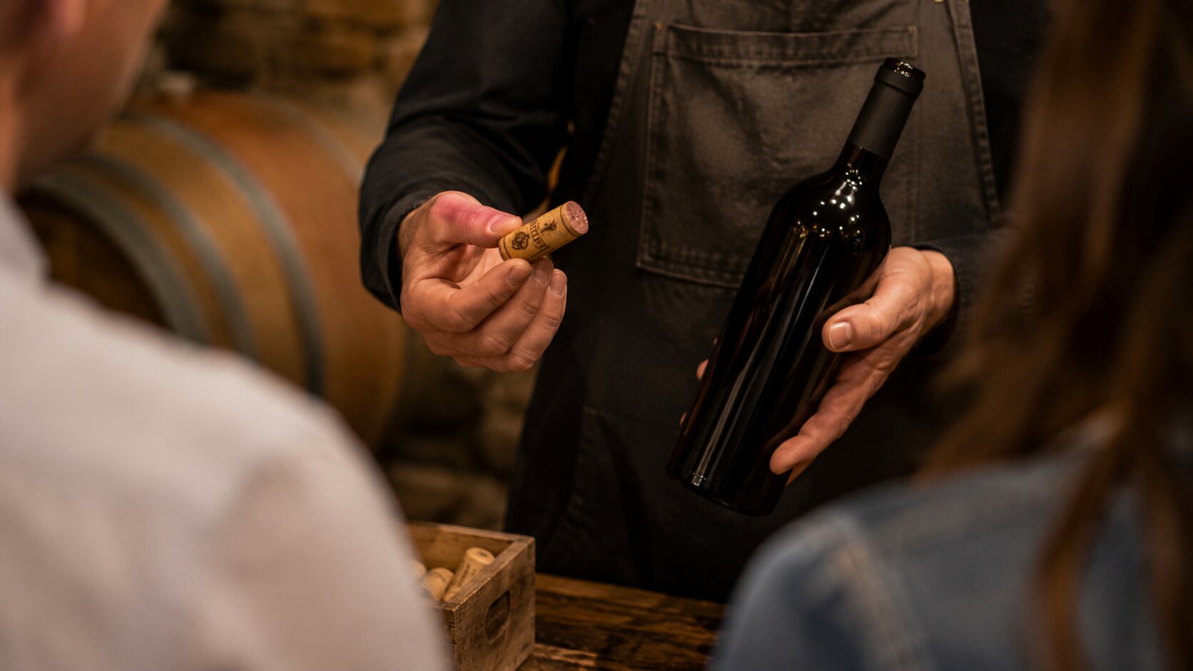 Winemaker explaining a wine cork during a cellar tour